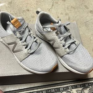 Excellent condition New Balance shoes. Grey with brown detail